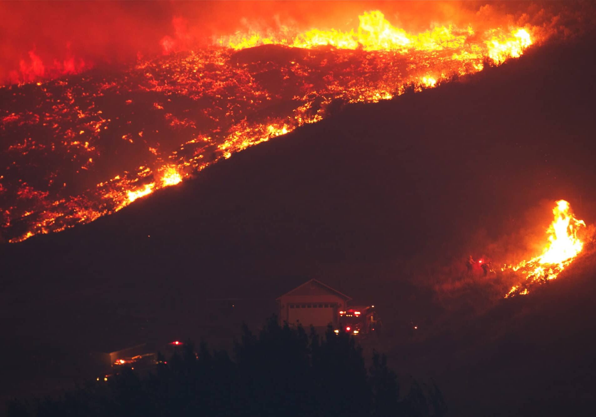 Hill on fire and first responders trying to put it out